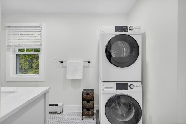 8 Wild Rose Pl, Waterford, CT 06385 - laundry room with stacked washer and clothes dryer, a baseboard heating unit, tile patterned flooring, and baseboards
