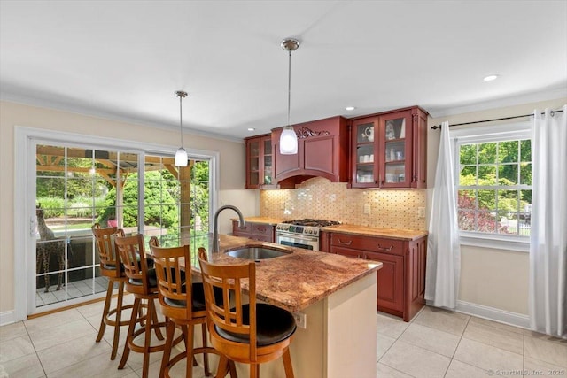 452 Burnt Plains Rd, Milford, CT 06461 - kitchen featuring high end stainless steel range, a sink, light tile patterned flooring, ornamental molding, and tasteful backsplash