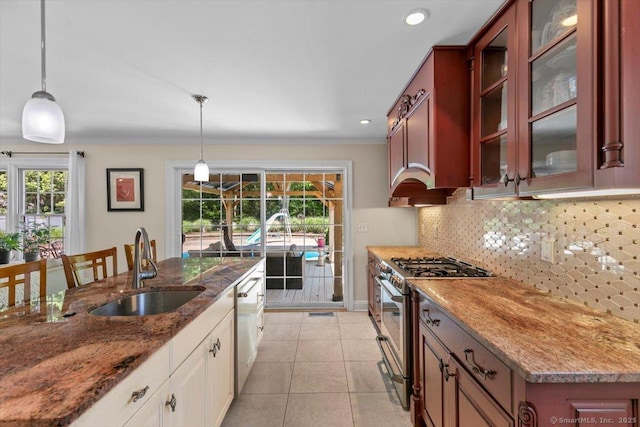 452 Burnt Plains Rd, Milford, CT 06461 - kitchen featuring appliances with stainless steel finishes, a sink, decorative backsplash, glass insert cabinets, and decorative light fixtures