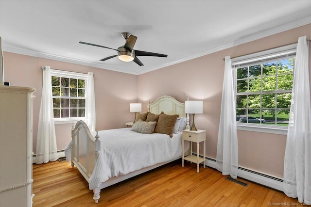 452 Burnt Plains Rd, Milford, CT 06461 - bedroom with multiple windows, light wood finished floors, ornamental molding, a ceiling fan, and a baseboard heating unit