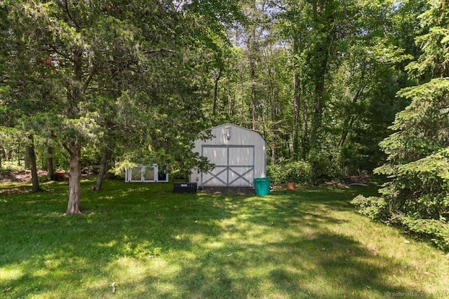 452 Burnt Plains Rd, Milford, CT 06461 - view of grassy yard with central air condition unit and a forest view