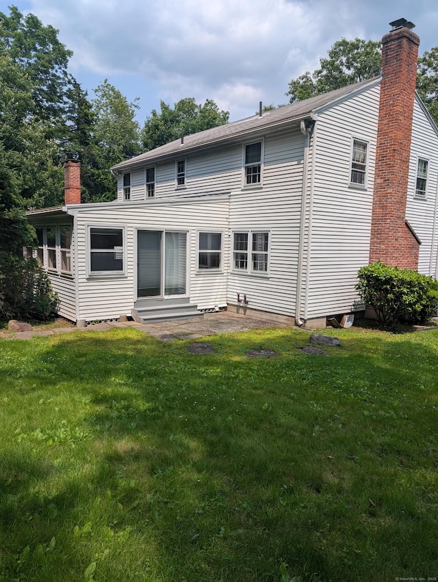 1060 Still Hill Rd, Hamden, CT 06518 - rear view of house with a chimney, a lawn, and entry steps