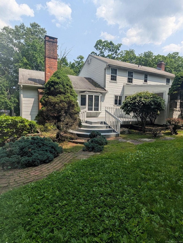 1060 Still Hill Rd, Hamden, CT 06518 - rear view of house featuring a chimney, a yard, and a wooden deck