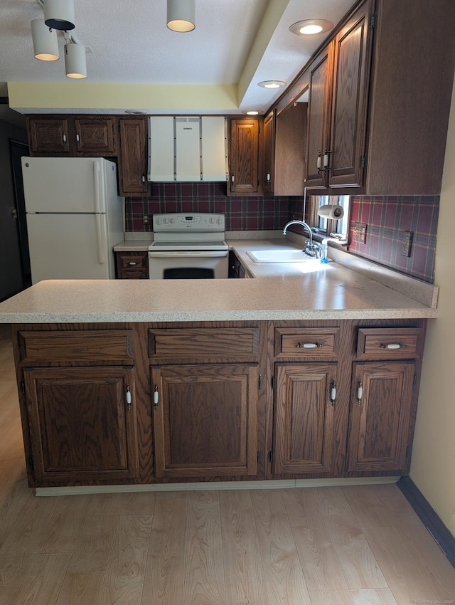 1060 Still Hill Rd, Hamden, CT 06518 - kitchen featuring white appliances, light countertops, light wood finished floors, and tasteful backsplash