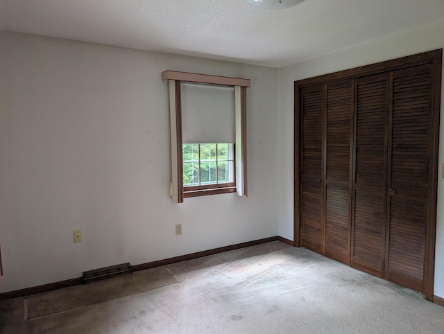 1060 Still Hill Rd, Hamden, CT 06518 - unfurnished bedroom featuring light carpet, a closet, and a textured ceiling