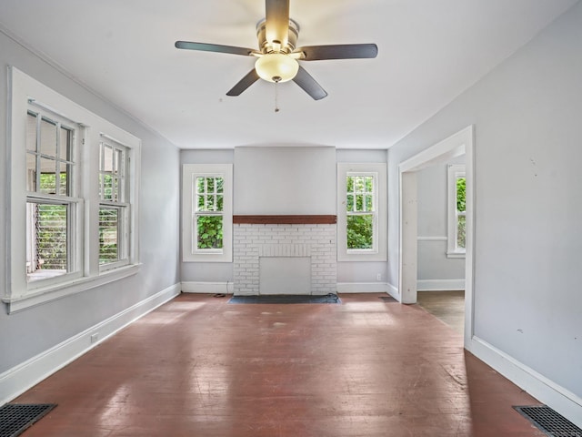 1 Raymond Ter, Norwalk, CT 06855 - unfurnished living room with healthy amount of natural light, a fireplace, wood-type flooring, and a ceiling fan