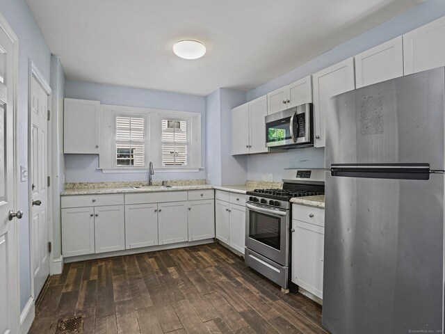 1 Raymond Ter, Norwalk, CT 06855 - kitchen with stainless steel appliances, white cabinetry, and dark wood-style flooring