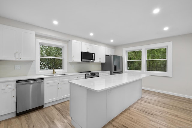 123 Lower Rd, North Canaan, CT 06024 - kitchen with stainless steel appliances, plenty of natural light, a center island, white cabinetry, and recessed lighting