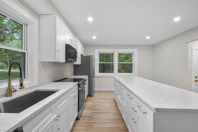 123 Lower Rd, North Canaan, CT 06024 - kitchen with stainless steel range with electric cooktop, black microwave, plenty of natural light, light wood finished floors, and recessed lighting