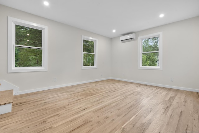 123 Lower Rd, North Canaan, CT 06024 - spare room with an AC wall unit, light wood-style flooring, and recessed lighting