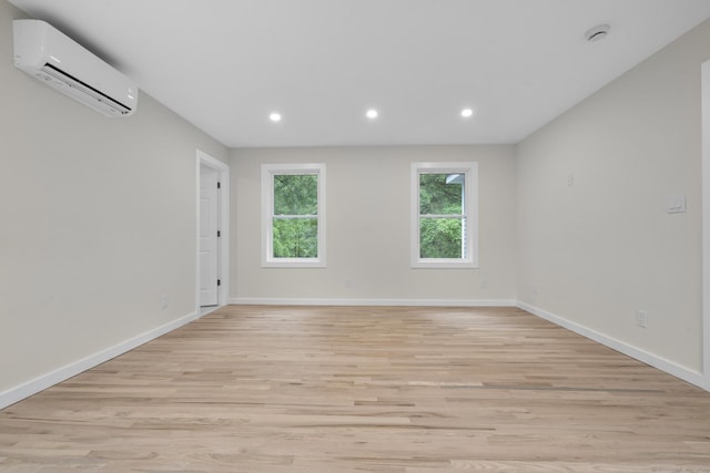 123 Lower Rd, North Canaan, CT 06024 - unfurnished room with an AC wall unit, light wood-type flooring, and recessed lighting
