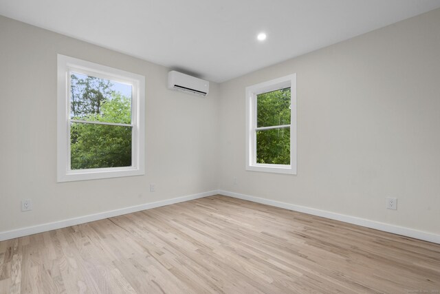 123 Lower Rd, North Canaan, CT 06024 - unfurnished room featuring a wall unit AC, plenty of natural light, wood finished floors, and recessed lighting
