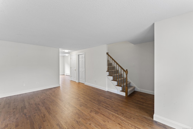 107 Greens Loop, Cheshire, CT 06410 - unfurnished living room featuring stairs, wood finished floors, and a textured ceiling