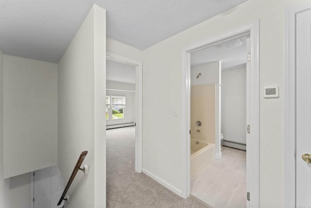 107 Greens Loop, Cheshire, CT 06410 - hallway featuring baseboard heating, a baseboard radiator, an upstairs landing, a textured ceiling, and light carpet