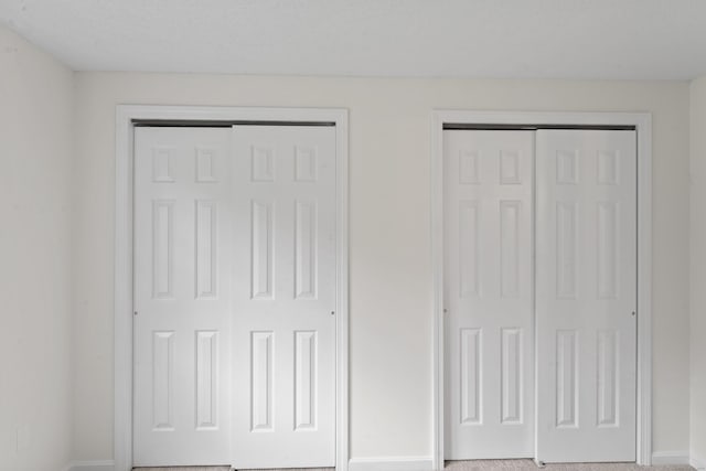 107 Greens Loop, Cheshire, CT 06410 - unfurnished bedroom featuring two closets and baseboards