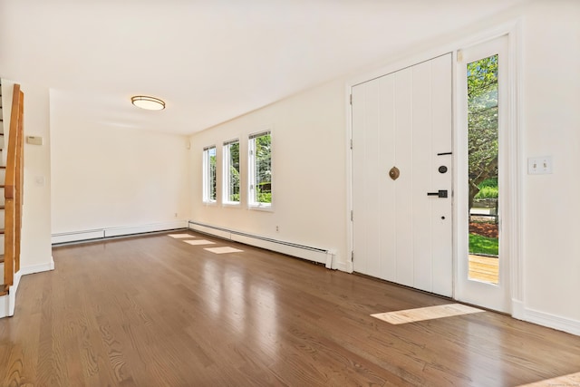 15 Grumman Ave, Norwalk, CT 06851 - foyer entrance featuring a baseboard heating unit, wood finished floors, and stairway