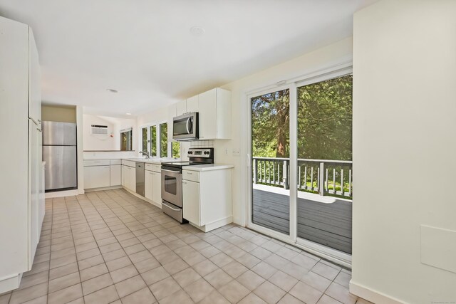 15 Grumman Ave, Norwalk, CT 06851 - kitchen featuring appliances with stainless steel finishes, plenty of natural light, light countertops, and white cabinetry