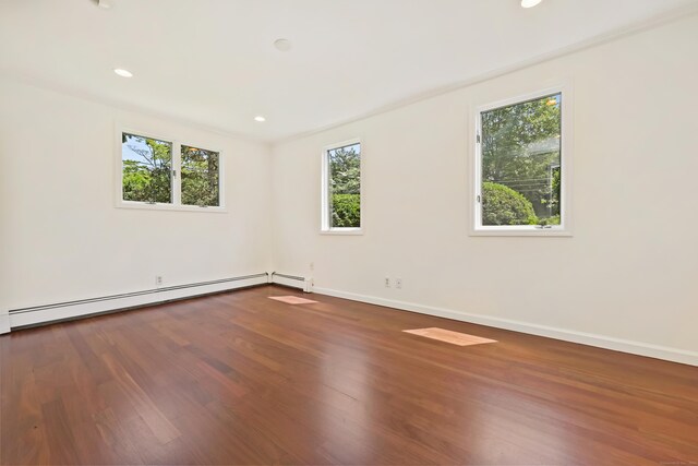 15 Grumman Ave, Norwalk, CT 06851 - unfurnished room featuring a baseboard heating unit, plenty of natural light, wood finished floors, and recessed lighting