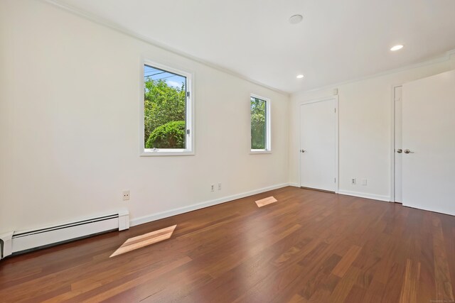 15 Grumman Ave, Norwalk, CT 06851 - unfurnished bedroom with wood finished floors, a baseboard radiator, and recessed lighting