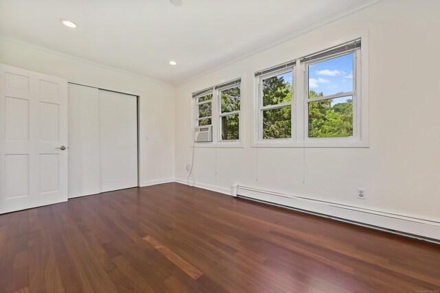 15 Grumman Ave, Norwalk, CT 06851 - unfurnished bedroom with a baseboard radiator, crown molding, multiple windows, dark wood finished floors, and a closet