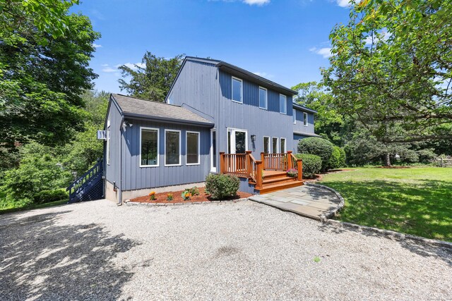 15 Grumman Ave, Norwalk, CT 06851 - view of front of home with a front yard, a deck, and driveway