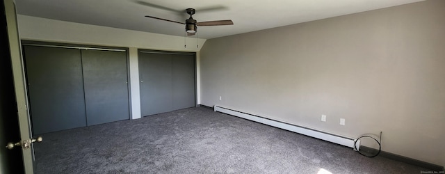552 Squaw Rock Rd, Plainfield, CT 06354 - unfurnished bedroom with two closets, baseboard heating, dark colored carpet, and ceiling fan