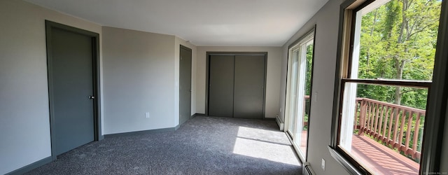 552 Squaw Rock Rd, Plainfield, CT 06354 - unfurnished bedroom featuring carpet, baseboard heating, baseboards, and a closet