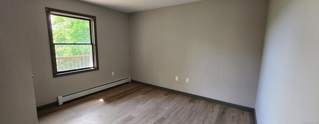 552 Squaw Rock Rd, Plainfield, CT 06354 - empty room featuring a baseboard radiator, wood finished floors, and baseboards