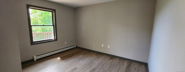 552 Squaw Rock Rd, Plainfield, CT 06354 - unfurnished room featuring baseboard heating, wood finished floors, and baseboards