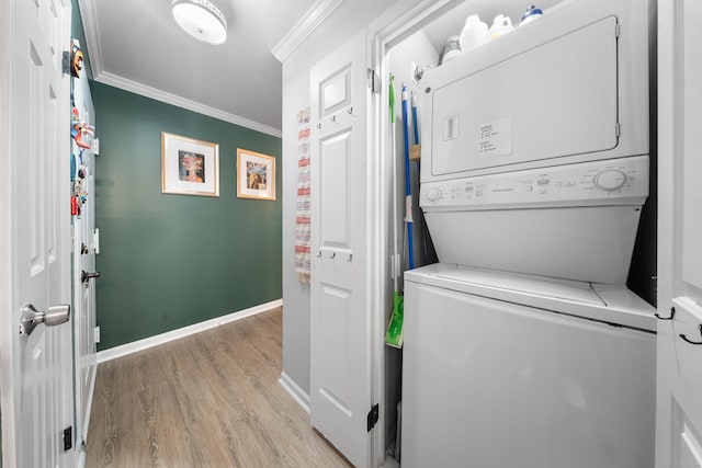 50 Aiken St Apt 463, Norwalk, CT 06851 - washroom with estacked washer and dryer, light wood-type flooring, ornamental molding, and baseboards