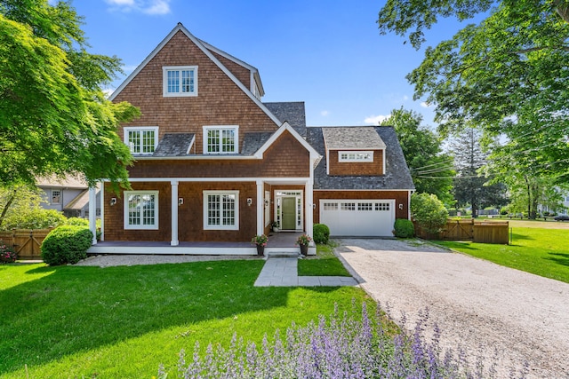 9 Milton Pl, Norwalk, CT 06853 - shingle-style home featuring a porch, gravel driveway, a garage, and roof with shingles