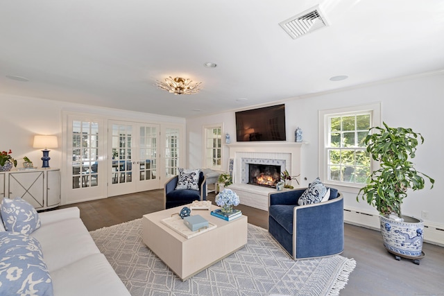 15 Mill Rd, New Canaan, CT 06840 - living area featuring french doors, wood finished floors, a lit fireplace, and ornamental molding