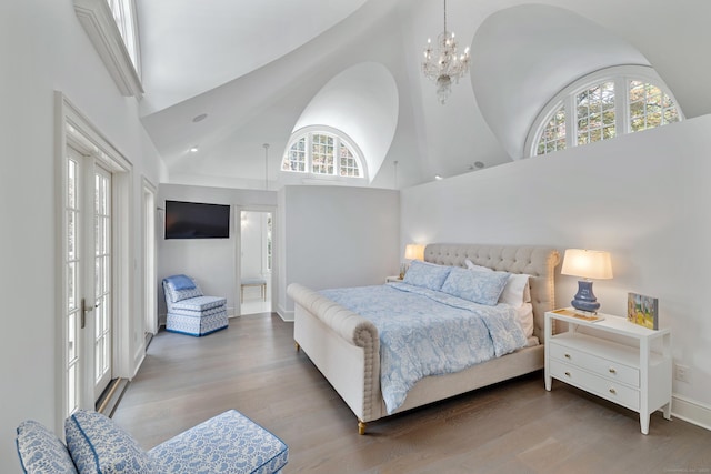 15 Mill Rd, New Canaan, CT 06840 - bedroom featuring high vaulted ceiling, a chandelier, wood finished floors, and connected bathroom