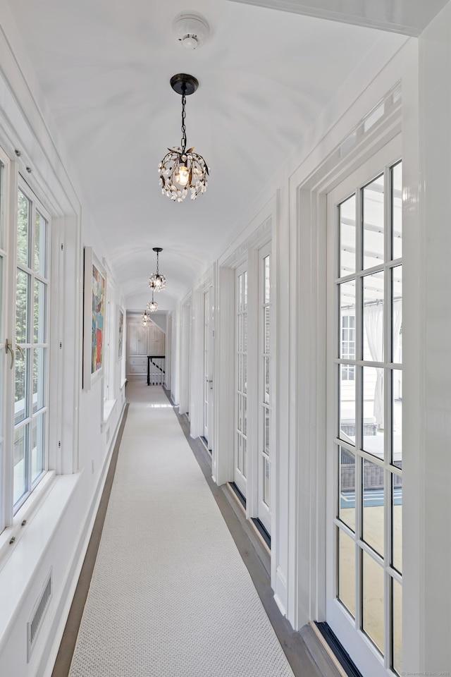 15 Mill Rd, New Canaan, CT 06840 - hall with a chandelier, healthy amount of natural light, and baseboards