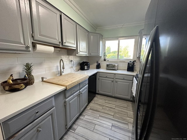 184 Kennedy Dr Unit 184, Bridgeport, CT 06606 - kitchen with black appliances, gray cabinetry, decorative backsplash, ornamental molding, and light countertops