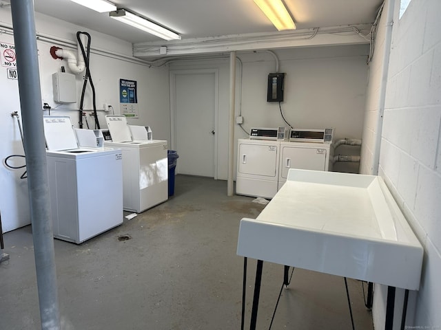 184 Kennedy Dr Unit 184, Bridgeport, CT 06606 - shared laundry with washer and clothes dryer, concrete block wall, and electric panel