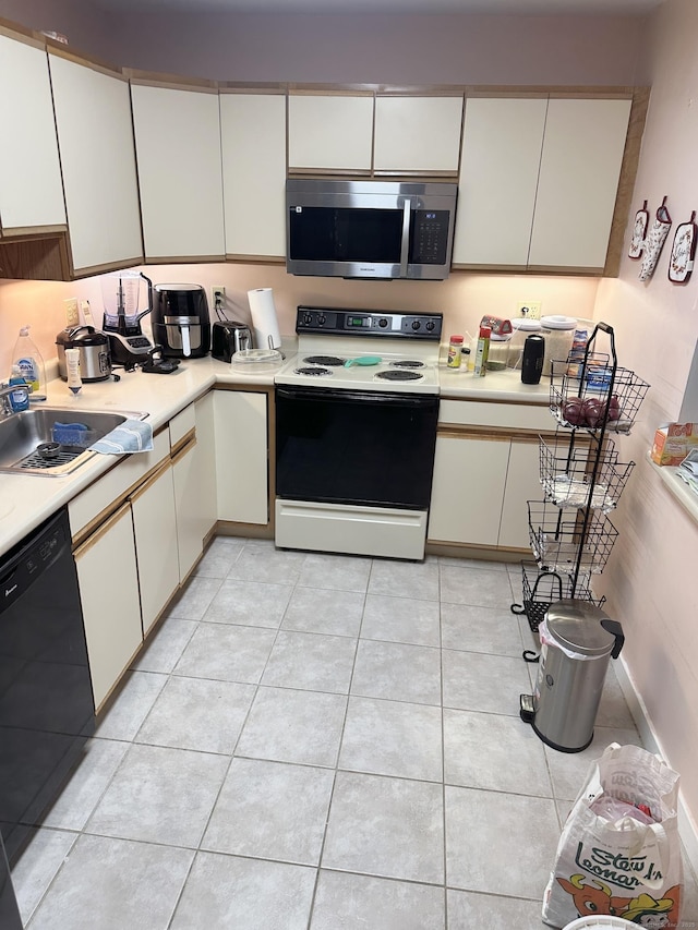 664 Main Ave Apt 302, Norwalk, CT 06851 - kitchen featuring white range with electric cooktop, stainless steel microwave, black dishwasher, a sink, and light countertops