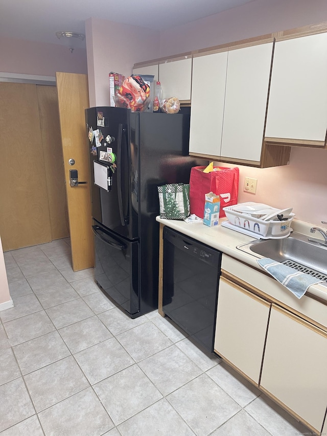 664 Main Ave Apt 302, Norwalk, CT 06851 - kitchen with black appliances, a sink, light countertops, white cabinets, and light tile patterned floors