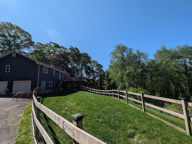 51 Isleib Rd, Marlborough, CT 06447 - view of yard with asphalt driveway, stairway, an attached garage, and a wooden deck
