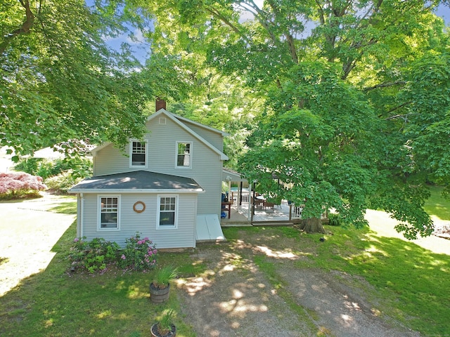 276 Boston Post Rd, East Lyme, CT 06333 - view of front facade featuring a chimney, a deck, and a front yard