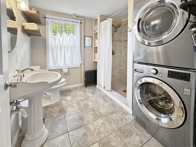 276 Boston Post Rd, East Lyme, CT 06333 - bathroom with stacked washer / drying machine, a stall shower, radiator, and toilet