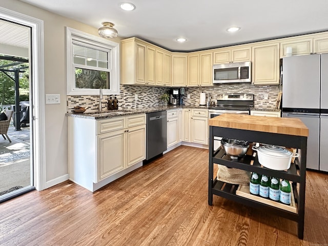 276 Boston Post Rd, East Lyme, CT 06333 - kitchen with appliances with stainless steel finishes, cream cabinets, open shelves, light wood-style floors, and recessed lighting