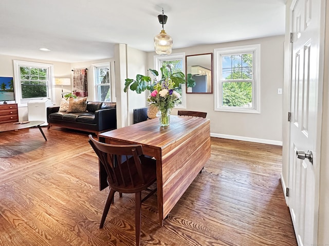276 Boston Post Rd, East Lyme, CT 06333 - dining area featuring wood finished floors, baseboards, and radiator heating unit