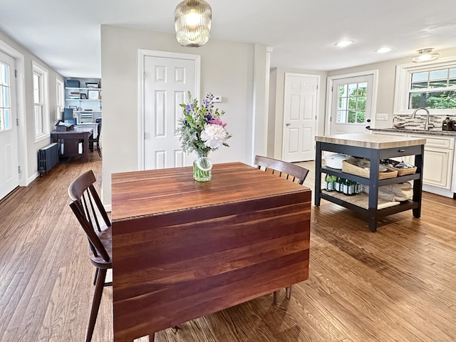276 Boston Post Rd, East Lyme, CT 06333 - dining area with radiator heating unit, wood finished floors, a chandelier, and recessed lighting