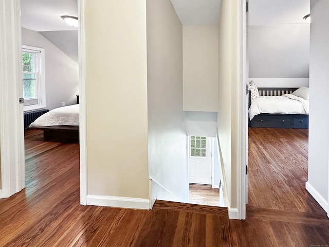 276 Boston Post Rd, East Lyme, CT 06333 - corridor featuring radiator heating unit, wood finished floors, baseboards, and vaulted ceiling