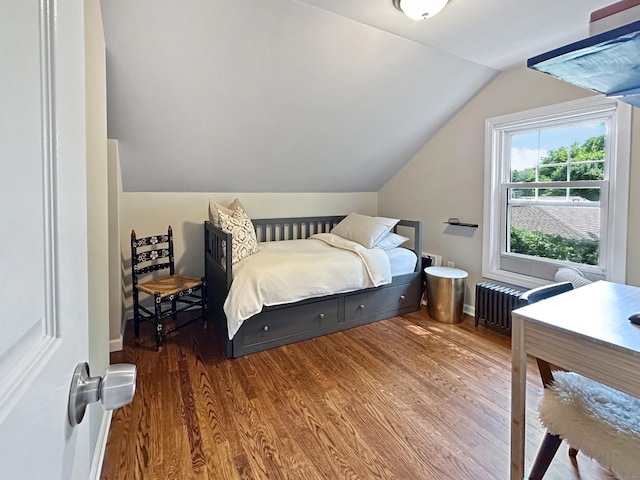 276 Boston Post Rd, East Lyme, CT 06333 - bedroom featuring wood finished floors, vaulted ceiling, radiator heating unit, and baseboards