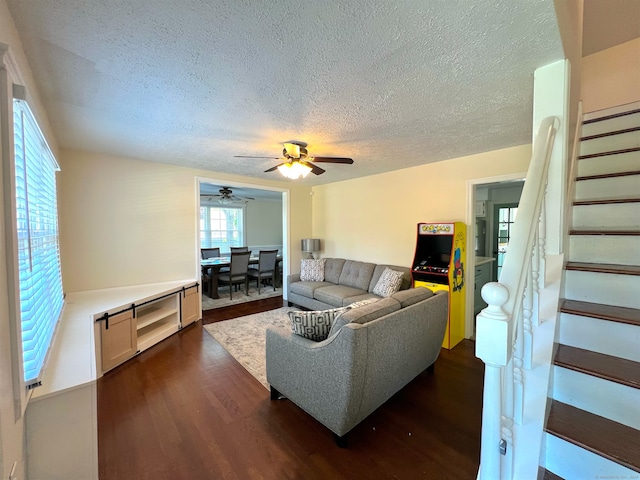 55 Lancaster St, Watertown, CT 06779 - living room featuring a textured ceiling, stairs, dark wood-type flooring, and ceiling fan