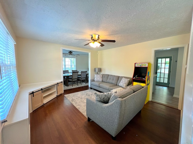 55 Lancaster St, Watertown, CT 06779 - living area featuring dark wood-type flooring, a textured ceiling, healthy amount of natural light, and ceiling fan