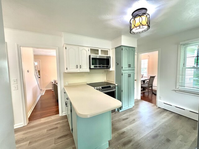 55 Lancaster St, Watertown, CT 06779 - kitchen featuring stainless steel appliances, a peninsula, light wood-style flooring, light countertops, and a baseboard heating unit