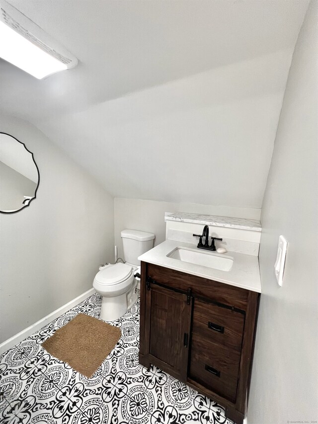 55 Lancaster St, Watertown, CT 06779 - half bathroom with lofted ceiling, toilet, vanity, and baseboards